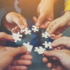 Blog Header Image - team holding puzzle pieces